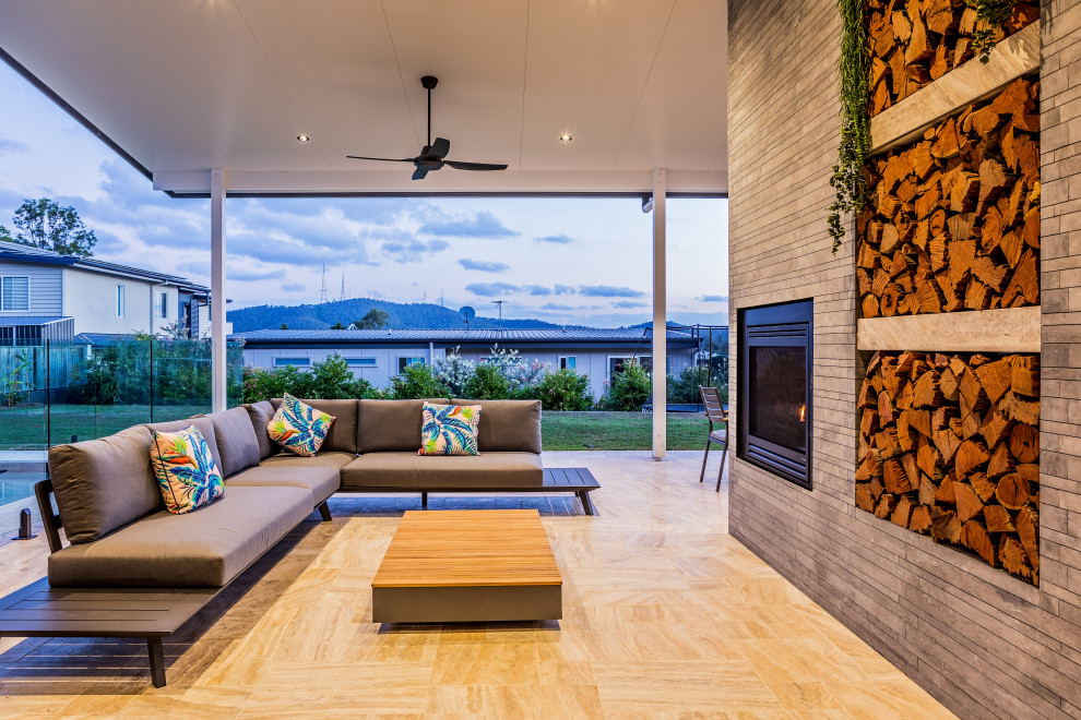 Inspiration for a contemporary patio in Brisbane with with fireplace and a roof extension.