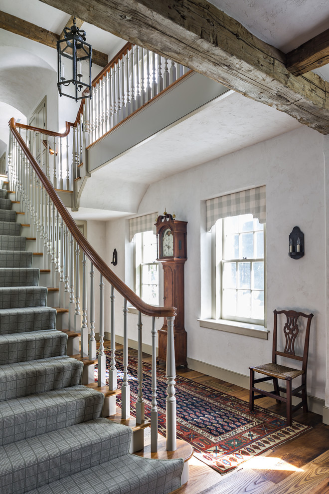 Staircase - huge country wooden u-shaped staircase idea in New York with painted risers