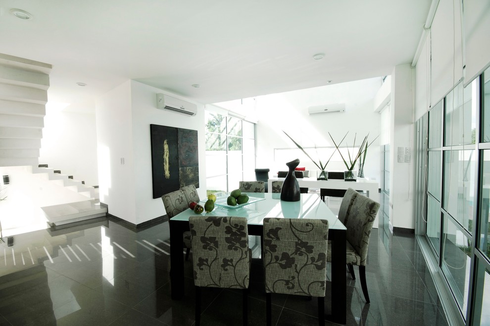 Modern dining room in Other with white walls.