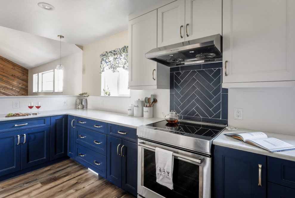 Mid-sized transitional galley vinyl floor and brown floor kitchen photo in Denver with shaker cabinets, blue cabinets, quartz countertops, white backsplash, ceramic backsplash, stainless steel appliances and white countertops