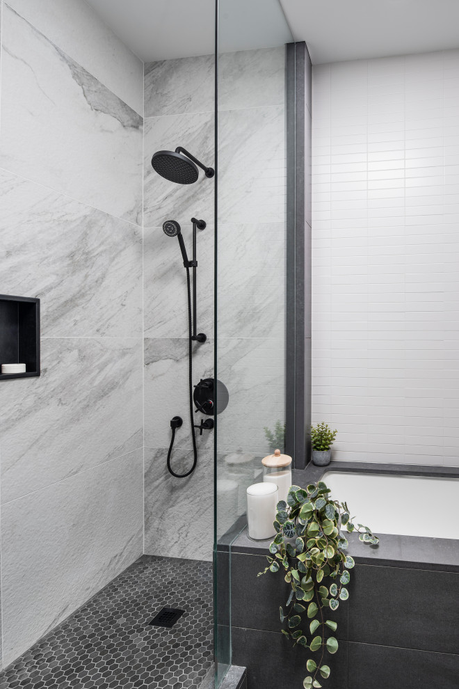 Inspiration for a mid-sized scandinavian master bathroom in Toronto with flat-panel cabinets, light wood cabinets, an undermount tub, an alcove shower, a one-piece toilet, white tile, ceramic tile, grey walls, ceramic floors, an undermount sink, wood benchtops, a hinged shower door and grey benchtops.