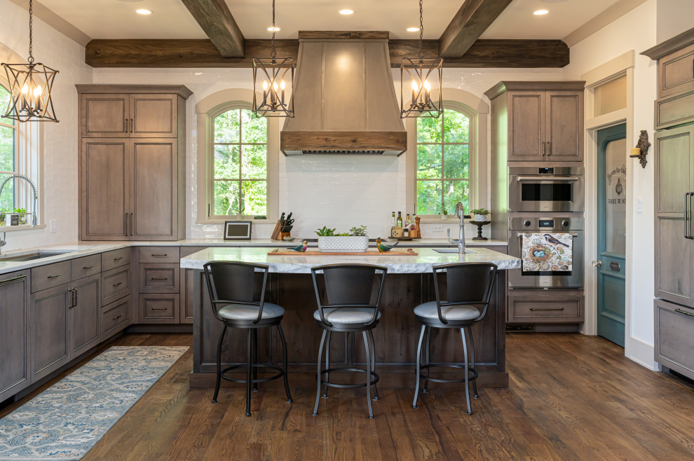 Open concept kitchen - mid-sized transitional u-shaped medium tone wood floor, brown floor and exposed beam open concept kitchen idea with an undermount sink, recessed-panel cabinets, medium tone wood cabinets, marble countertops, white backsplash, paneled appliances, an island, multicolored countertops and ceramic backsplash