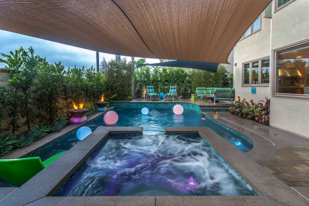 Hot tub - transitional backyard natural hot tub idea in Orange County