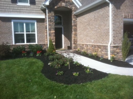 This is an example of a mid-sized transitional full sun front yard landscaping for spring.