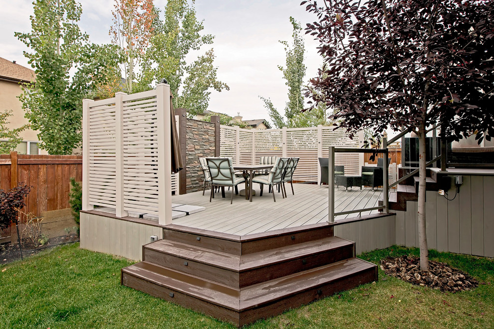 Photo of a large transitional backyard deck in Calgary with no cover.