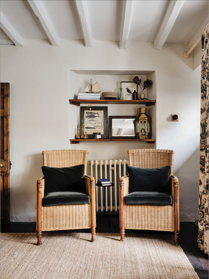 Inspiration for a mid-sized country enclosed living room in Oxfordshire with white walls, dark hardwood floors, a concealed tv, brown floor and exposed beam.