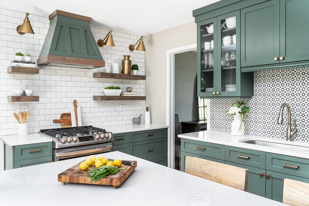 Photo of a mid-sized transitional u-shaped separate kitchen in Chicago with an undermount sink, shaker cabinets, green cabinets, quartz benchtops, white splashback, cement tile splashback, stainless steel appliances, light hardwood floors, with island and white benchtop.