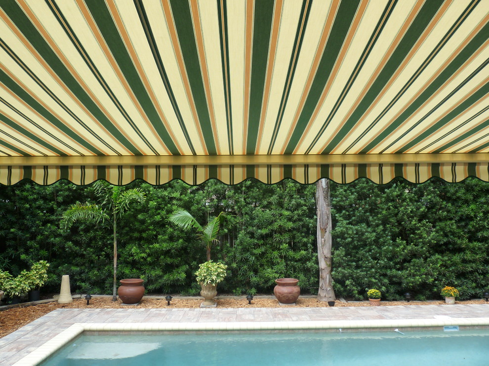 Photo of a tropical backyard patio in Orlando with an awning.