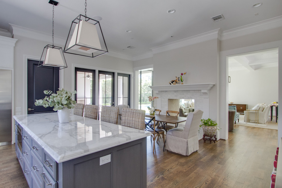 Transitional open plan kitchen in Houston with recessed-panel cabinets and with island.