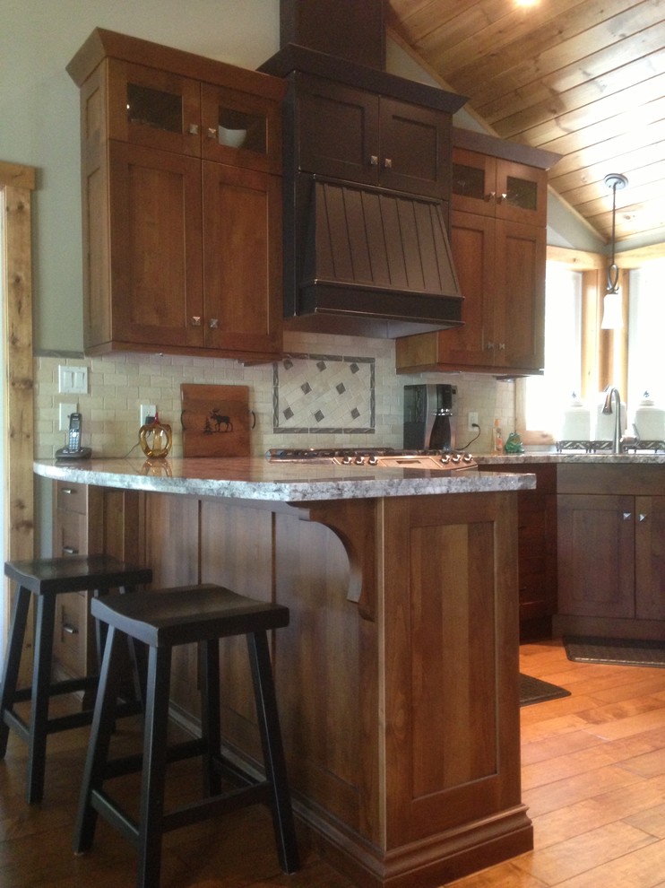 Mid-sized mountain style u-shaped medium tone wood floor eat-in kitchen photo in Toronto with a double-bowl sink, stainless steel appliances, shaker cabinets, dark wood cabinets, quartz countertops, multicolored backsplash and ceramic backsplash