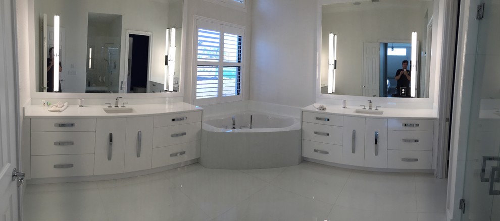 Mid-sized contemporary master bathroom in Miami with flat-panel cabinets, white cabinets, glass benchtops and white walls.