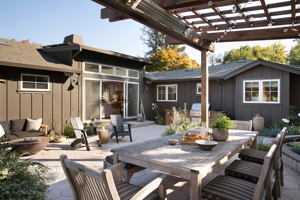 This is an example of a mid-sized transitional backyard patio in San Francisco with a pergola.