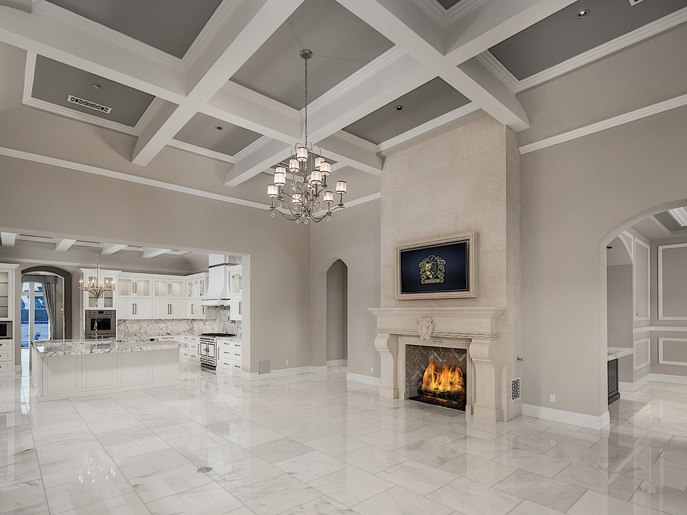 Inspiration for an expansive traditional open concept family room in Phoenix with a home bar, multi-coloured walls, marble floors, a standard fireplace, a stone fireplace surround, a wall-mounted tv and multi-coloured floor.