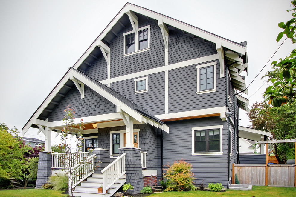 Design ideas for a mid-sized arts and crafts three-storey exterior in Seattle with wood siding and a gable roof.