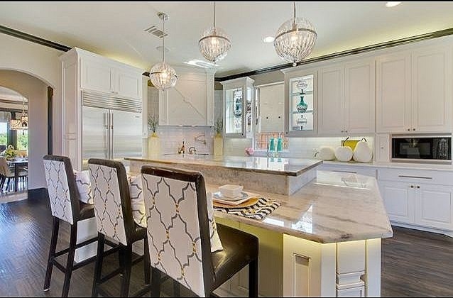 Photo of a contemporary u-shaped separate kitchen in Dallas with white cabinets, marble benchtops and white splashback.