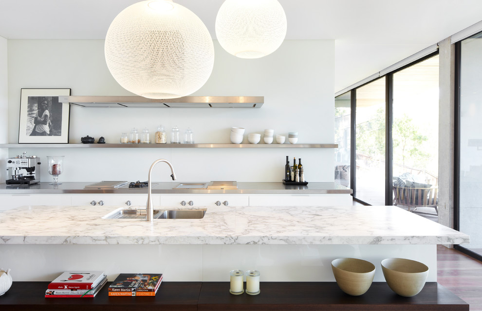 Design ideas for a contemporary galley kitchen in Sydney with a double-bowl sink, flat-panel cabinets, white cabinets, dark hardwood floors and with island.