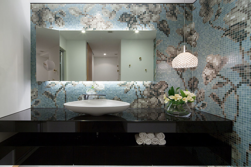 This is an example of a contemporary powder room in Other with multi-coloured walls, a vessel sink, brown tile, beige tile, blue tile, multi-coloured tile and mosaic tile.