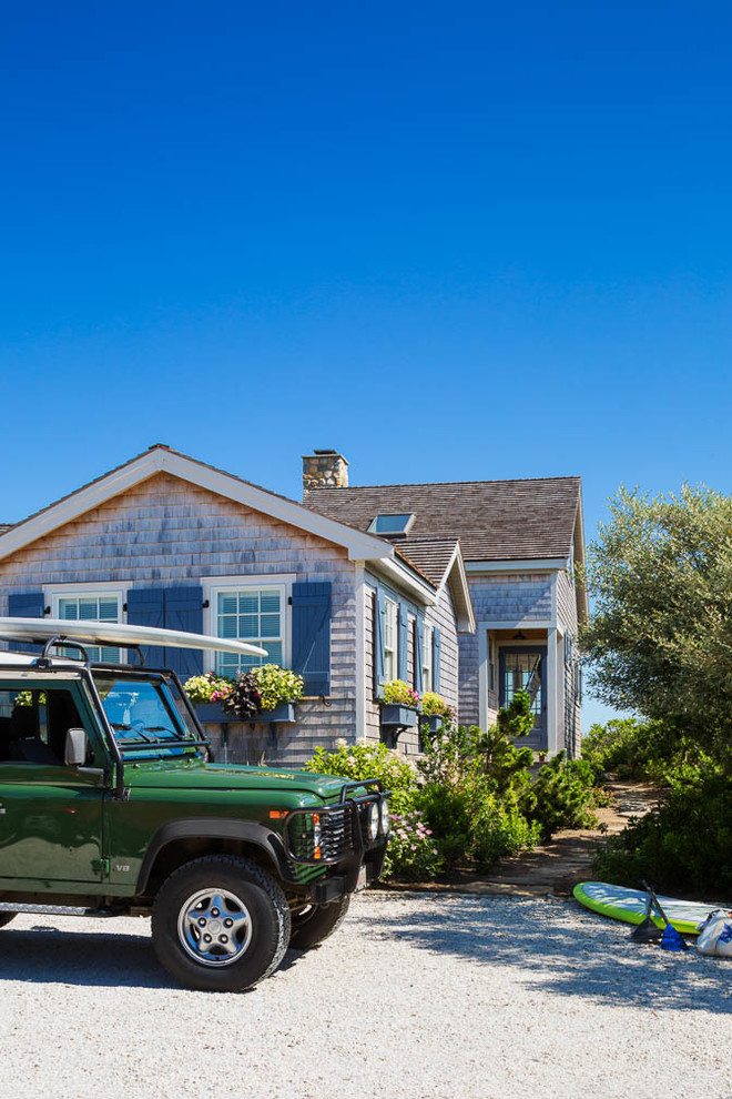 Inspiration for a small coastal two-story wood exterior home remodel in Boston with a shed roof
