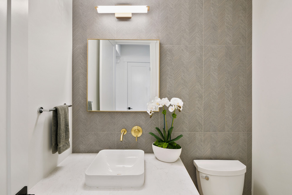 Mid-sized cottage gray tile and cement tile powder room photo in Seattle with a one-piece toilet, white walls, a vessel sink and a built-in vanity