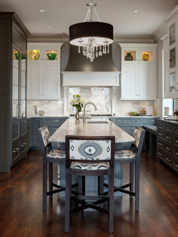 Inspiration for a transitional u-shaped kitchen in Chicago with recessed-panel cabinets, grey cabinets, white splashback, dark hardwood floors, with island and quartzite benchtops.
