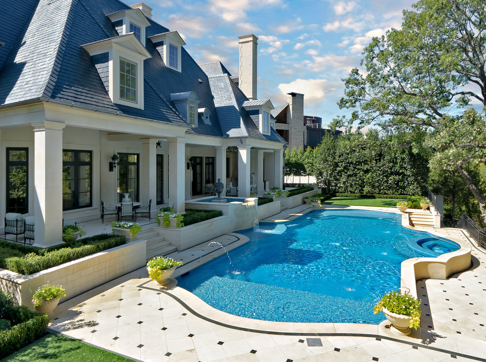 Traditional custom-shaped pool in Dallas with a water feature.
