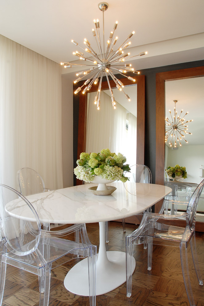 This is an example of a transitional dining room in Los Angeles with beige walls and medium hardwood floors.