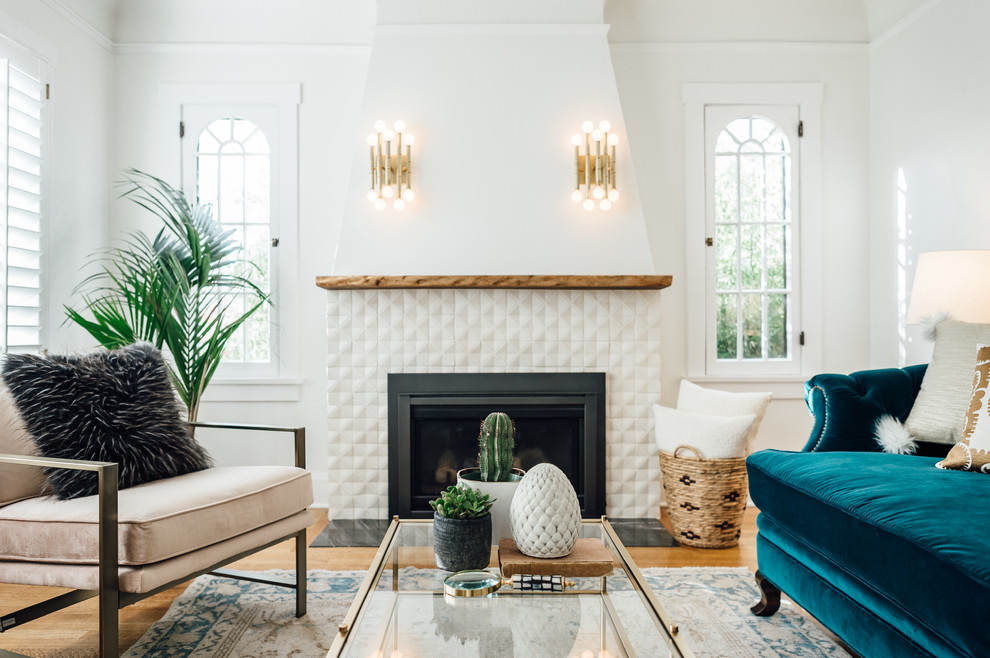 Inspiration for a mid-sized traditional living room in Salt Lake City with white walls, a standard fireplace, a tile fireplace surround and light hardwood floors.