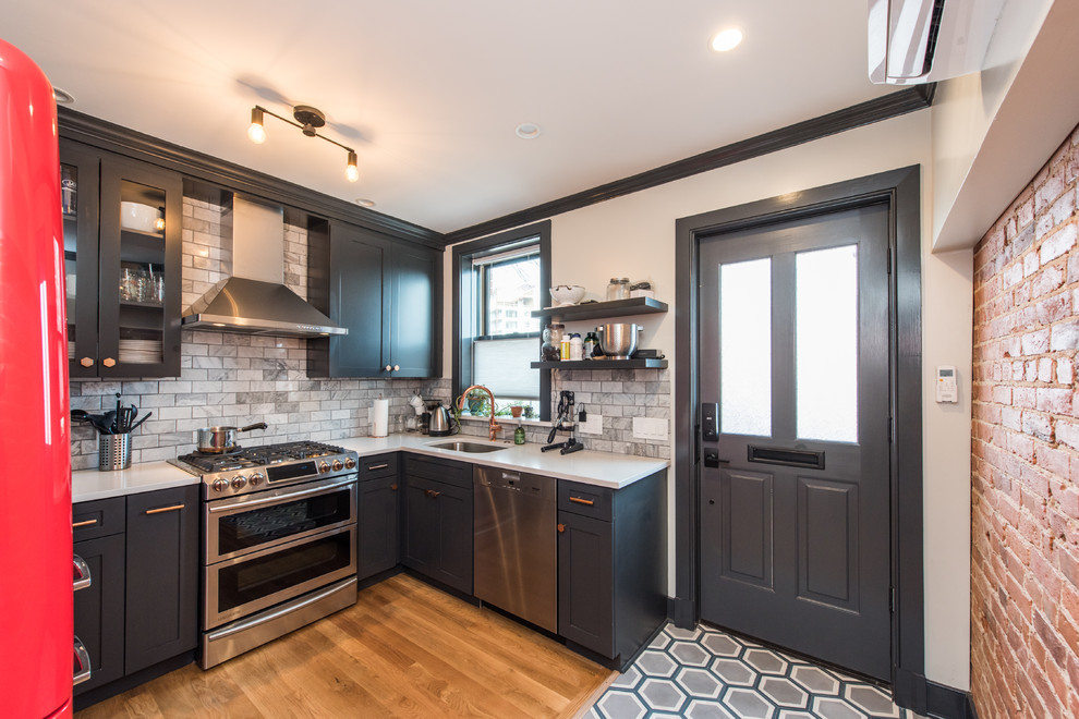 Mid-sized transitional u-shaped separate kitchen in DC Metro with an undermount sink, recessed-panel cabinets, green cabinets, quartzite benchtops, grey splashback, subway tile splashback, stainless steel appliances, medium hardwood floors, no island and brown floor.