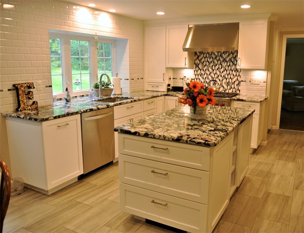 Kitchen - transitional kitchen idea in Boston with an undermount sink, shaker cabinets, granite countertops, subway tile backsplash, stainless steel appliances and an island