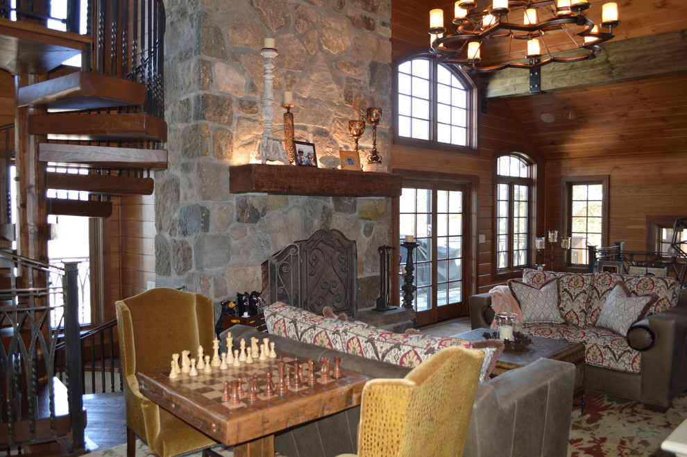 Example of a mountain style living room design in New York with a stone fireplace