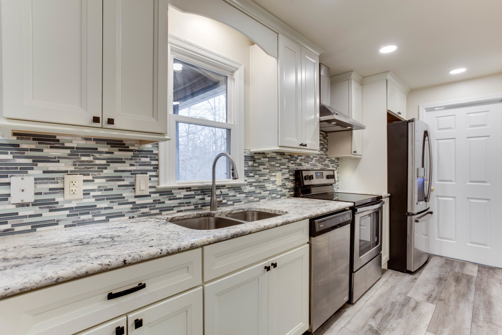 Inspiration for a large transitional u-shaped eat-in kitchen remodel in DC Metro with an undermount sink, granite countertops, stainless steel appliances and an island