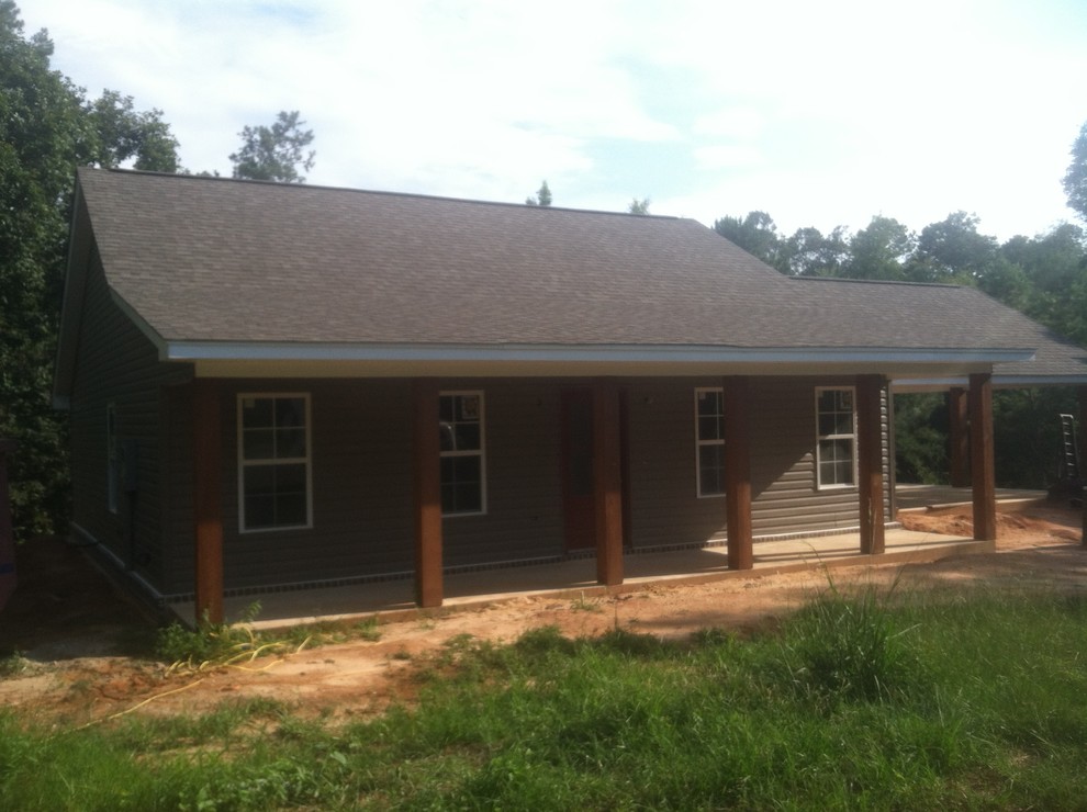Inspiration for a small rustic beige one-story vinyl exterior home remodel