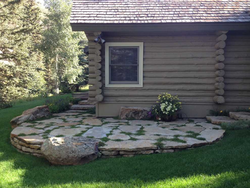 Photo of a country garden in Denver with natural stone pavers.