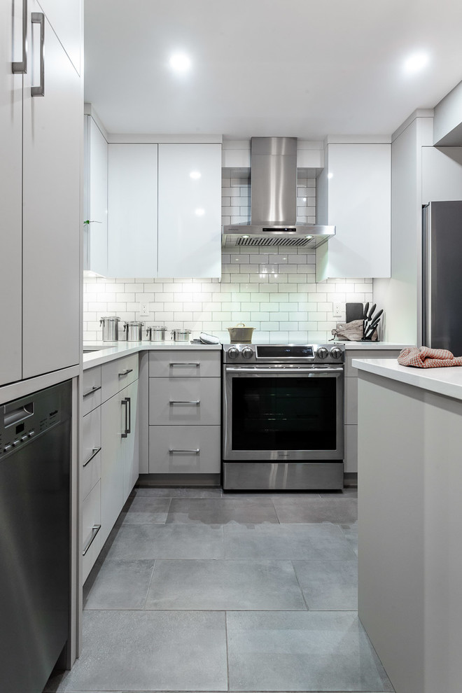 Inspiration for a small contemporary l-shaped kitchen in Vancouver with an undermount sink, flat-panel cabinets, grey cabinets, quartz benchtops, white splashback, subway tile splashback, stainless steel appliances, cement tiles, with island, grey floor and white benchtop.