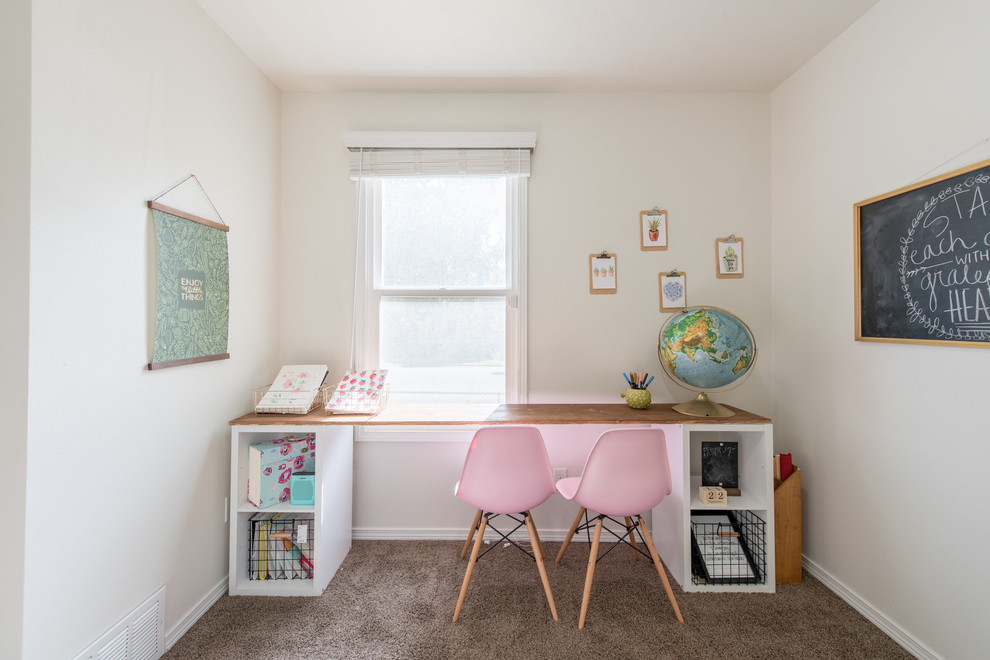 This is an example of a transitional kids' room for girls in Seattle with beige walls and carpet.