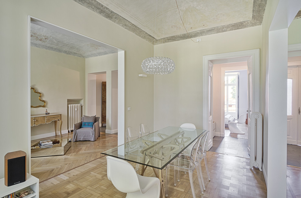 Mediterranean dining room in Amsterdam with beige walls, light hardwood floors and no fireplace.