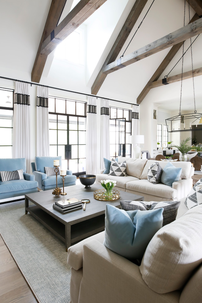 Inspiration for a transitional open concept living room in Nashville with white walls and light hardwood floors.