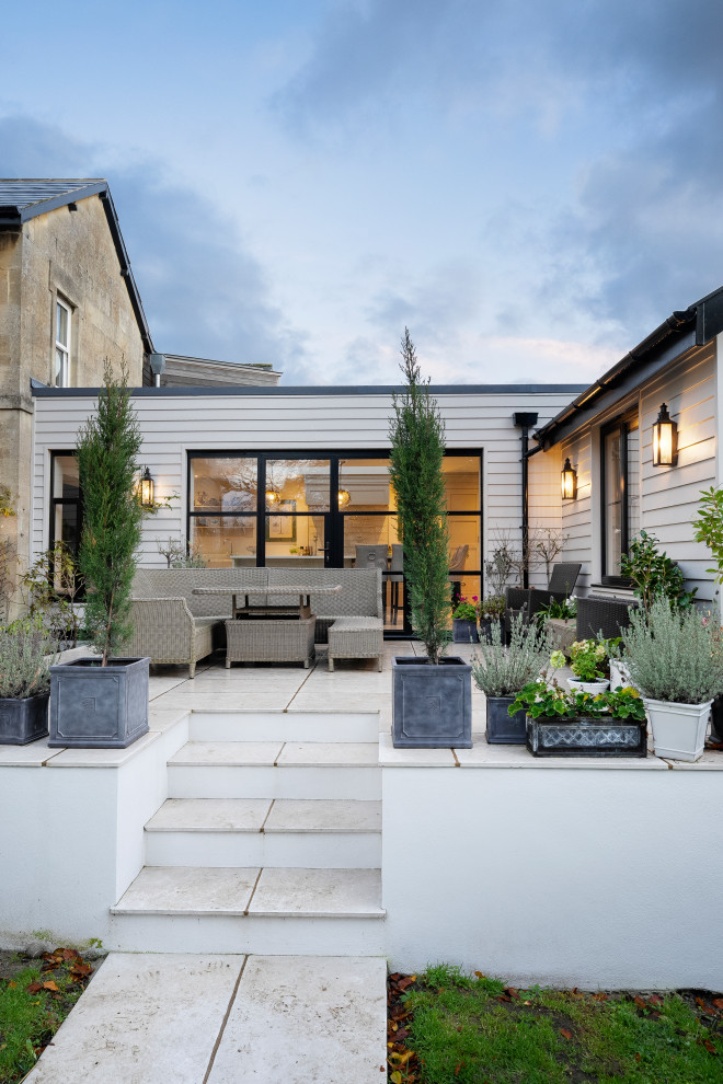 Diseño de fachada de casa gris y azul actual de tamaño medio de una planta con revestimiento de madera y tejado plano