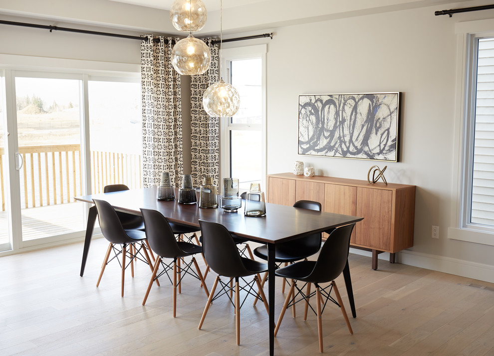 Inspiration for a transitional separate dining room in Edmonton with beige walls, light hardwood floors and beige floor.