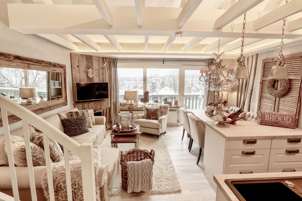 Mid-sized country formal enclosed living room in Hanover with white walls, light hardwood floors, a wall-mounted tv and beige floor.