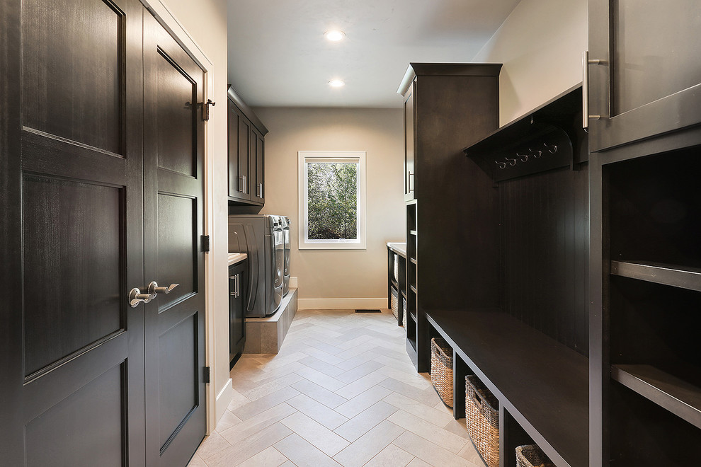 Transitional galley vinyl floor laundry room photo with an utility sink, shaker cabinets, dark wood cabinets, laminate countertops and a side-by-side washer/dryer