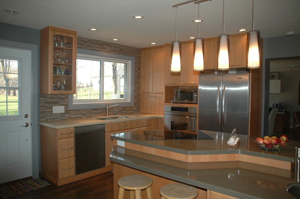 This is an example of a large contemporary l-shaped eat-in kitchen in Toronto with an undermount sink, flat-panel cabinets, light wood cabinets, quartzite benchtops, multi-coloured splashback, stainless steel appliances, with island, matchstick tile splashback and medium hardwood floors.
