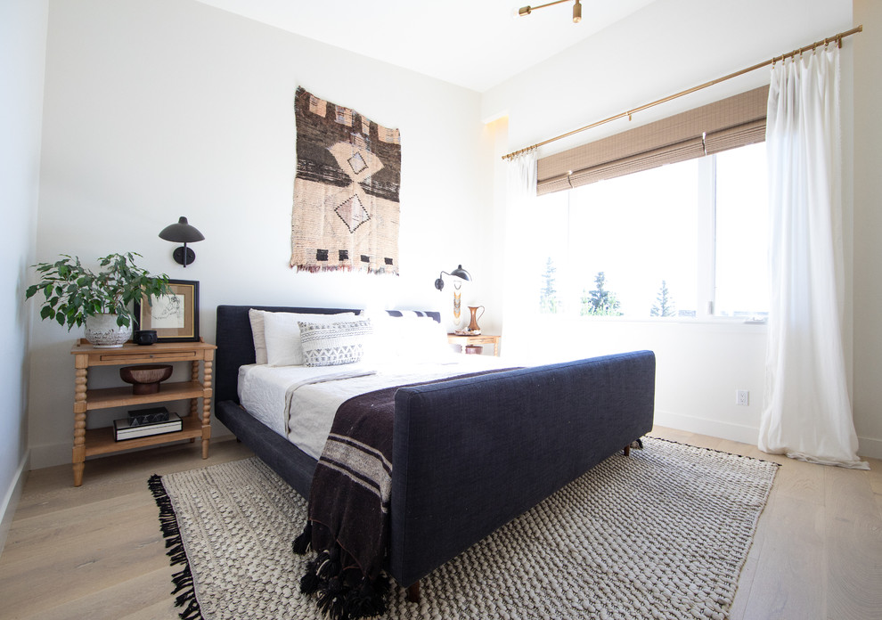Mid-sized danish master light wood floor and beige floor bedroom photo in Calgary with white walls and no fireplace