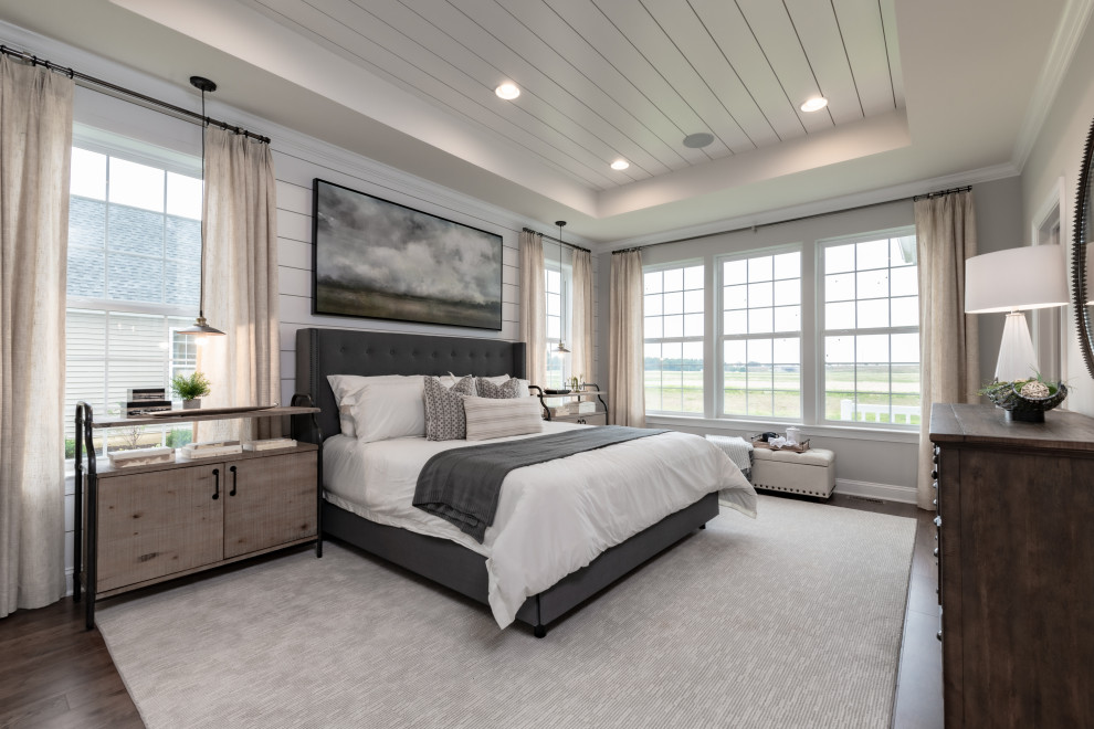 This is an example of a country master bedroom in Wilmington with grey walls, medium hardwood floors, no fireplace and brown floor.