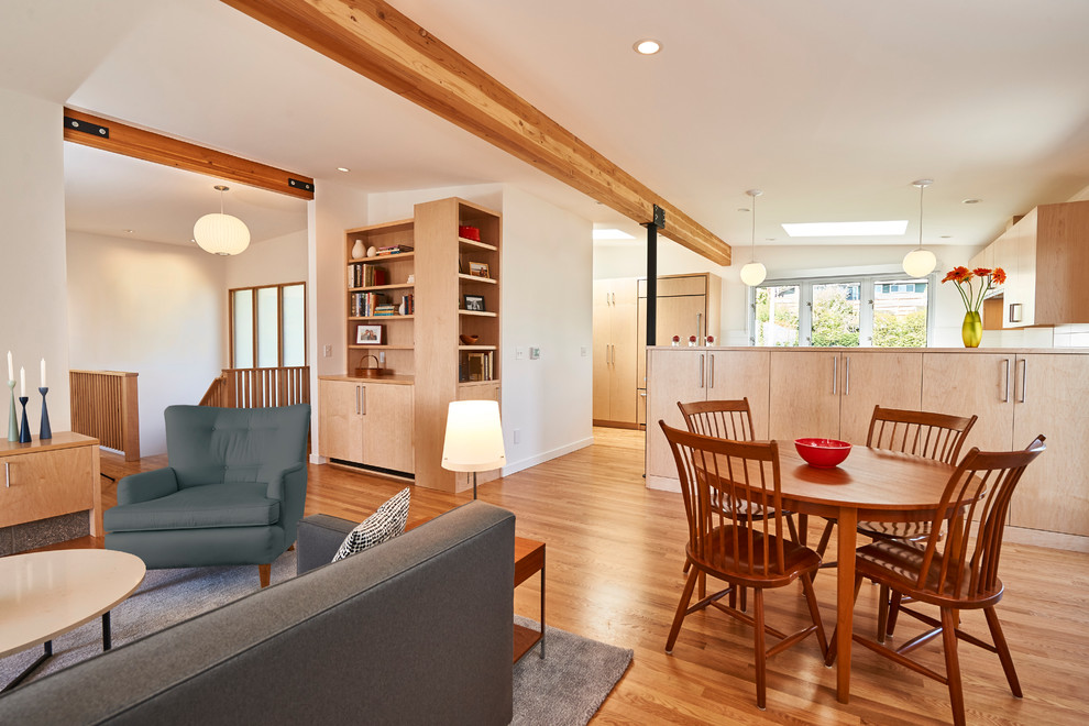 Design ideas for a mid-sized midcentury open concept living room in Seattle with white walls, medium hardwood floors and brown floor.