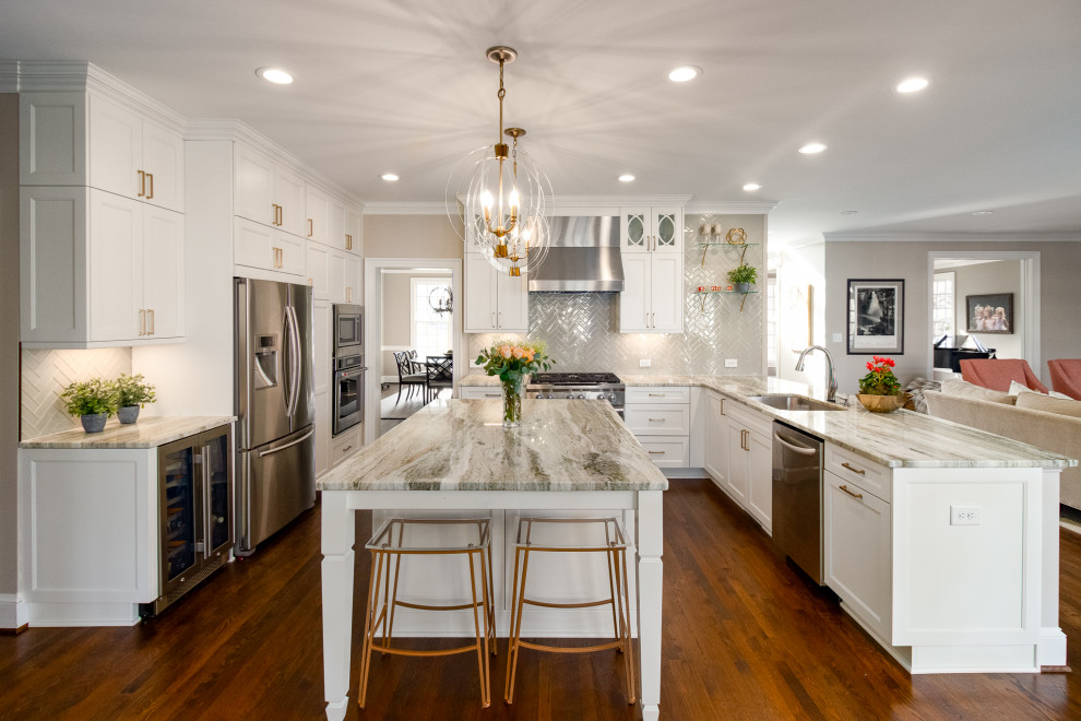 Design ideas for a transitional u-shaped kitchen in Raleigh with an undermount sink, white cabinets, marble benchtops, glass tile splashback, stainless steel appliances, with island, multi-coloured benchtop, shaker cabinets, grey splashback, dark hardwood floors and brown floor.