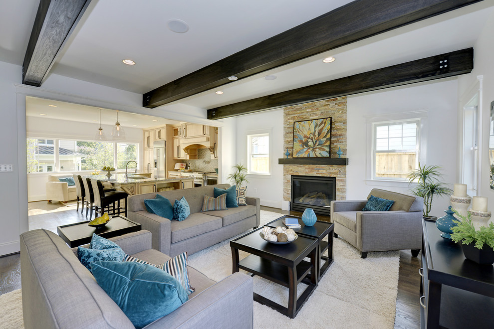 This is an example of a large transitional open concept family room in DC Metro with white walls, medium hardwood floors, a standard fireplace, a stone fireplace surround and no tv.