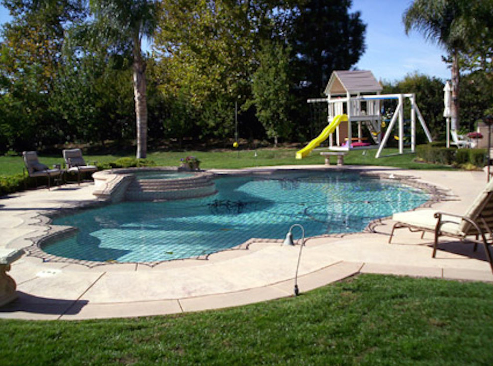 Hot tub - mid-sized backyard stone and custom-shaped hot tub idea in Miami