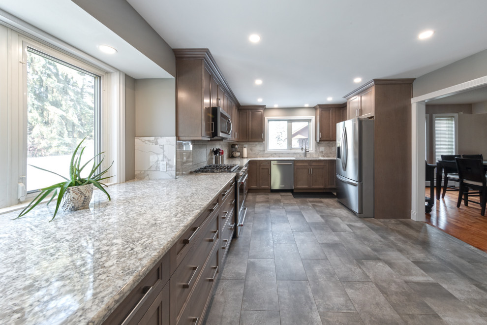 Example of a mid-sized classic l-shaped ceramic tile and gray floor enclosed kitchen design in Edmonton with a double-bowl sink, shaker cabinets, light wood cabinets, quartz countertops, white backsplash, ceramic backsplash, stainless steel appliances, no island and multicolored countertops