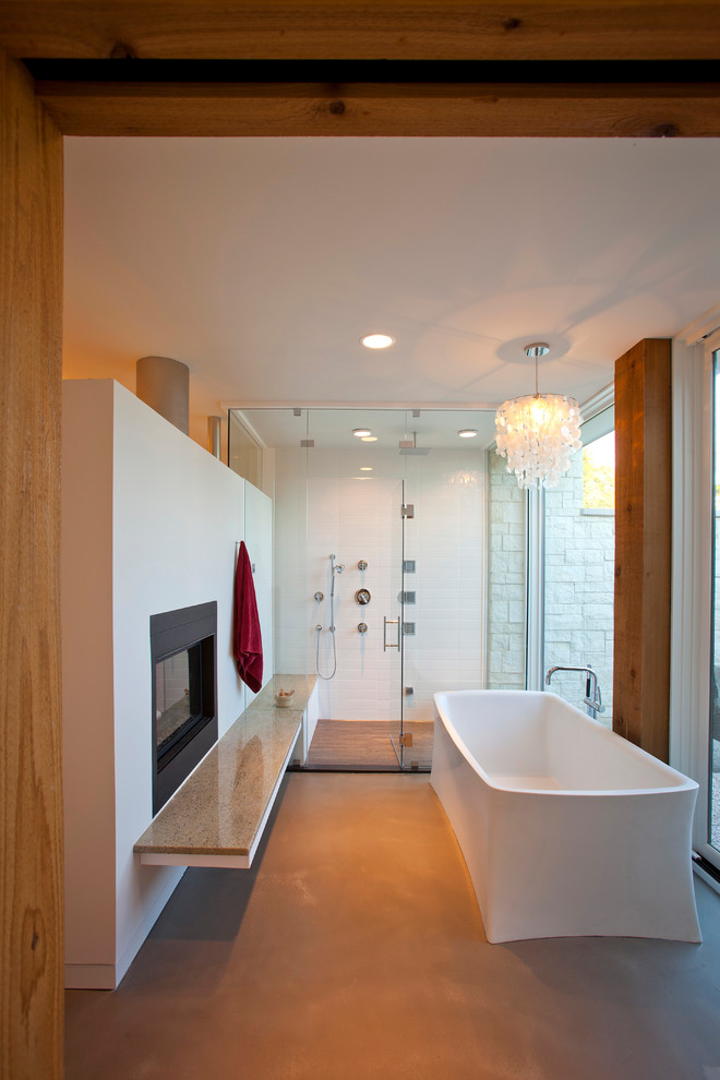 This is an example of a modern bathroom in Cincinnati with a freestanding tub, an alcove shower and white tile.